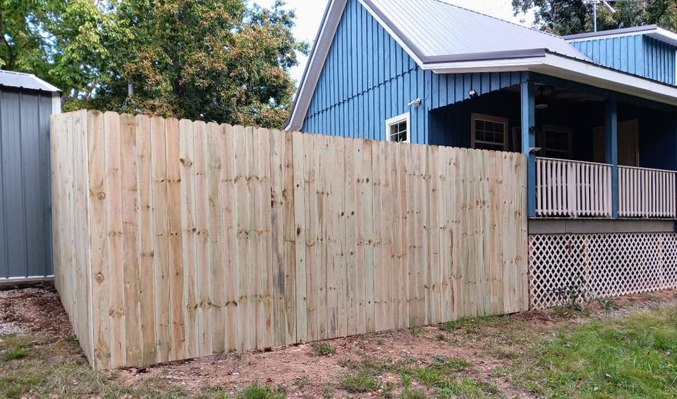A newly installed wood privacy fence by Higdon's fence install & repair in White Mills Junction, KY