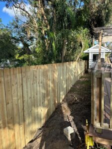 A newly installed wood privacy fence by Santis Fence & Home Service in Tampa Heights, FL