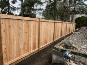 A long, newly installed wood privacy fence by Webb Fencing Pros in Seattle, WA.