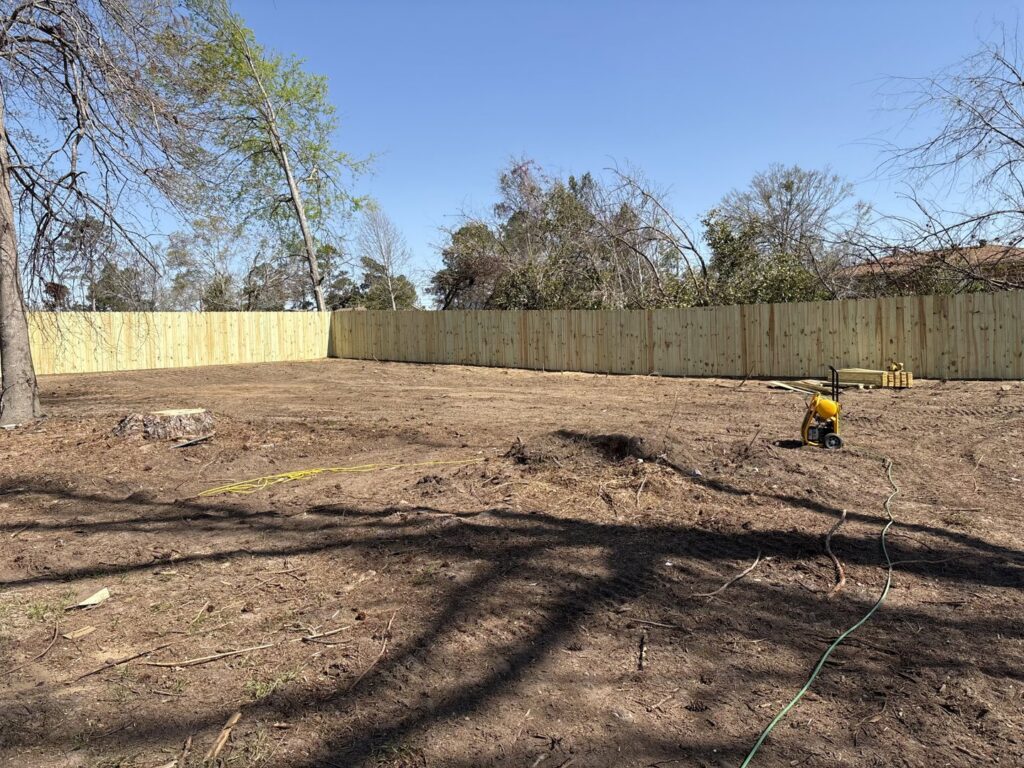 A new wood privacy fence installed on a large property by CSRA Solutions in Jackson, SC.
