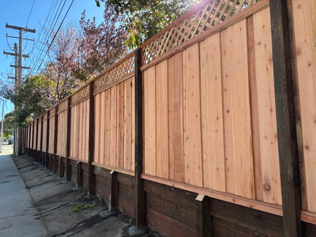 A newly installed wood privacy fence with a decorative lattice top by Jaz Builders Inc in Santa Clara, CA.