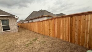 A new wood privacy fence installed in a residential backyard by C & M Affordable Fence, LLC in Haughton, LA