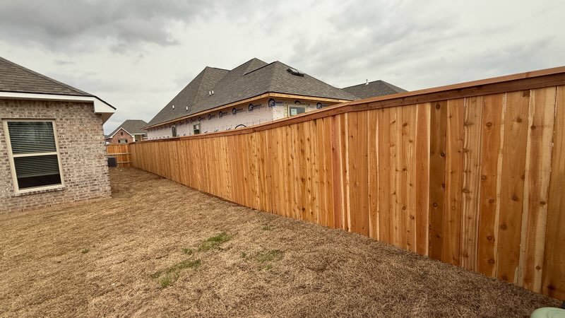 A new wood privacy fence installed in a residential backyard by C & M Affordable Fence, LLC in Haughton, LA