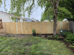 A newly installed wood privacy fence in a residential backyard by NC Fencing LLC in Wichita, KS.