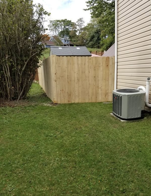 A newly installed wood privacy fence providing security for a residential property by Discount Fence Supply in Great Falls, SC.
