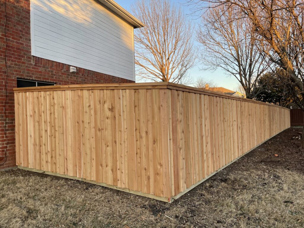 A newly installed wood privacy fence for a residential property by Franco Fence in Garland, TX.
