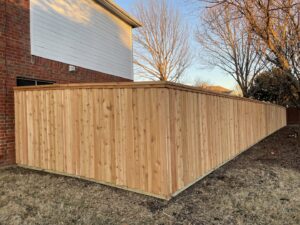 A newly installed wood privacy fence for a residential property by Franco Fence in Garland, TX.