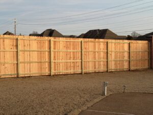 A newly constructed wooden privacy fence in a residential backyard by Integrity Fence & Outdoor Company in Jackson, TN.