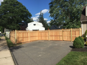 A newly installed wood privacy fence with decorative lattice tops for a residential property by Keith's Fence Co LLC in Edison, NJ.