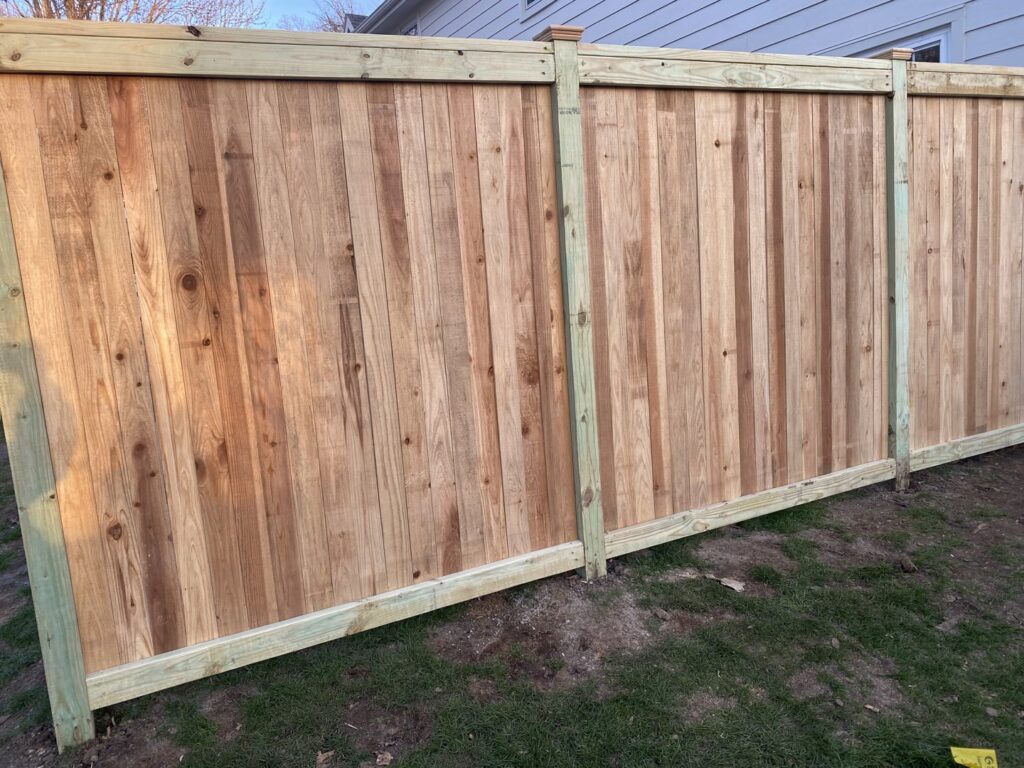 A new wood privacy fence installed for a residential property by Pride Fence in Peabody, MA.