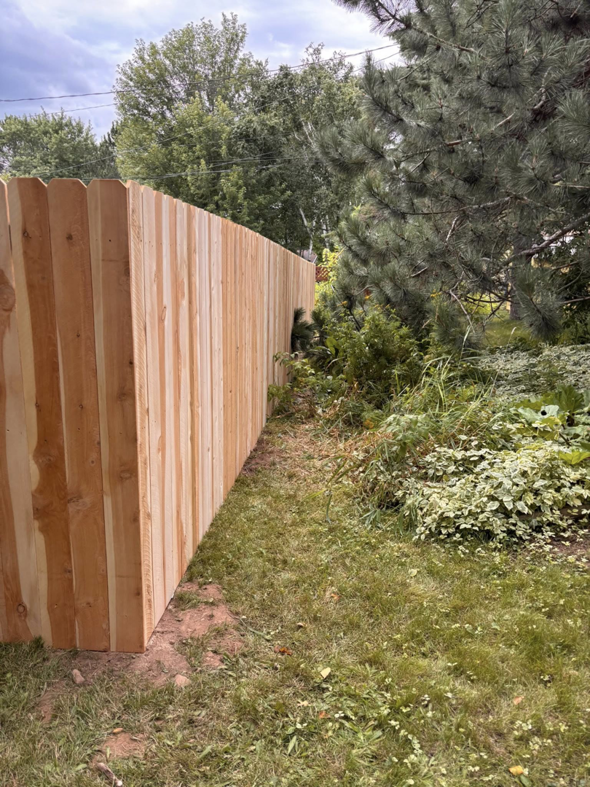A new wood privacy fence installed along a property line by 218 Fencing in Duluth, MN.