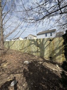 A newly installed wood privacy fence on a sloped residential backyard by Central Ohio Fence in Newark, OH.