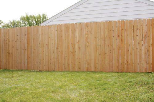 A newly installed wood privacy fence in a residential backyard by Western Fence & Landscape Supply in Caldwell, ID.