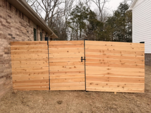 A newly installed wood privacy fence with a gate by Old School Fence Co. in Springfield, MO.