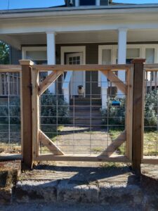 A newly installed wood and wire mesh gate at a residential property by Howell Fence Inc. in Oregon City, OR.