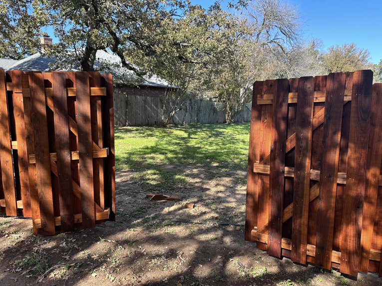 A newly installed wooden backyard fence with an open gate by Stevenson Brothers Fencing in Fort Worth, TX