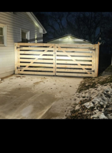 A newly installed wooden driveway gate by Schulze Enterprises in Bellevue, NE.