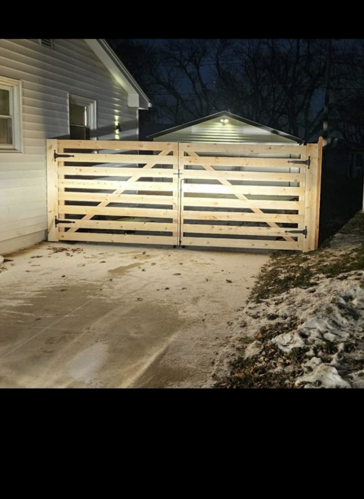 A newly installed wooden driveway gate by Schulze Enterprises in Bellevue, NE.