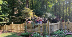A newly installed wooden picket fence with two gates by Arias Fence & Repair in Manassas, VA.