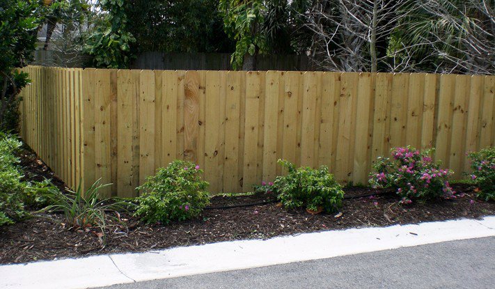 A newly installed wooden privacy fence with landscaping by Ace Fence Company in Fort Lauderdale, FL.