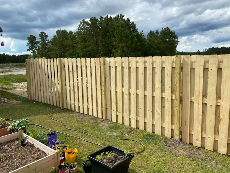 A newly installed wooden privacy fence enclosing a backyard by All In One Fence in Whitehouse Station, NJ.