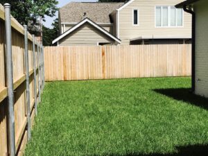 A new wooden privacy fence installed in a residential backyard by Amko Fence Co. in Kenner, LA.