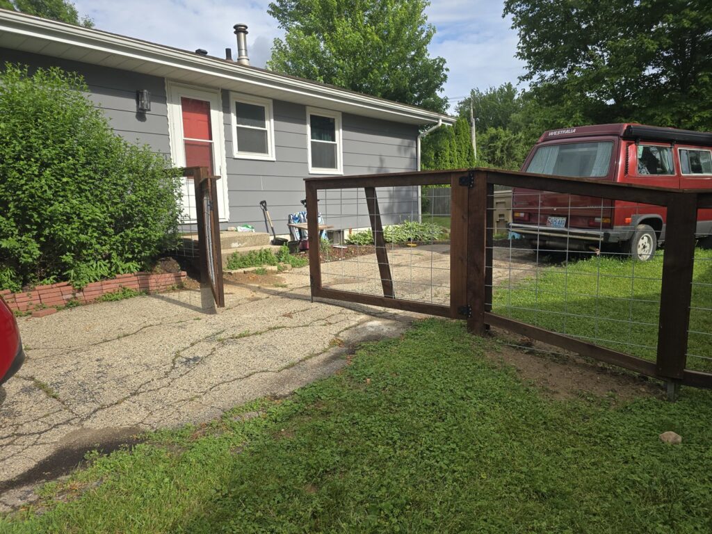 A newly installed wooden privacy fence enclosing a residential backyard by Brothers Fence Co. in Madison, WI.