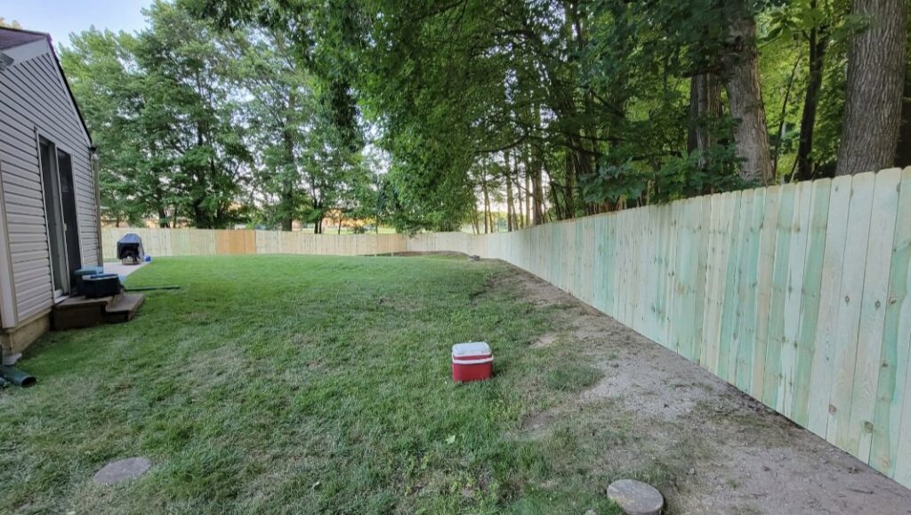 A newly installed wooden privacy fence enclosing a residential backyard by Concord Fence Llc in Wilmington, DE