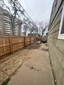 A newly installed wooden privacy fence in a residential backyard by First Rate Fence & Supply in Denver, CO.