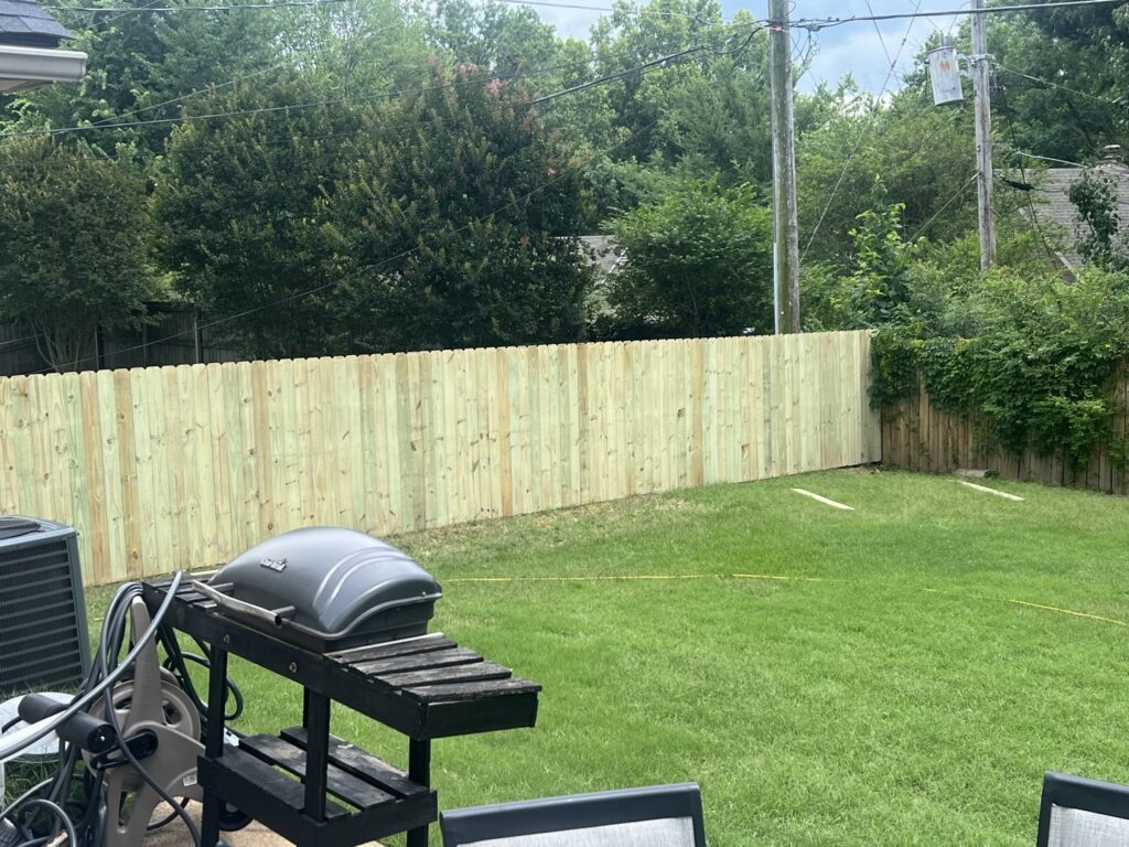 A newly installed wooden privacy fence enclosing a backyard by First Responder Outdoor Construction LLC in Bartlett, TN.