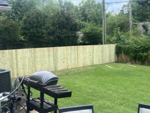 A newly installed wooden privacy fence enclosing a backyard by First Responder Outdoor Construction LLC in Bartlett, TN.