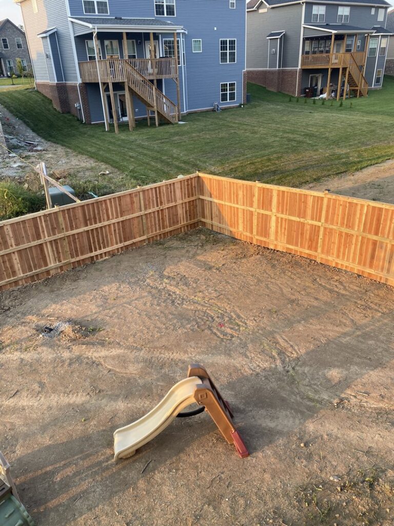 An aerial view of a newly installed wooden privacy fence enclosing a backyard by Roark Fencing in Lexington, KY