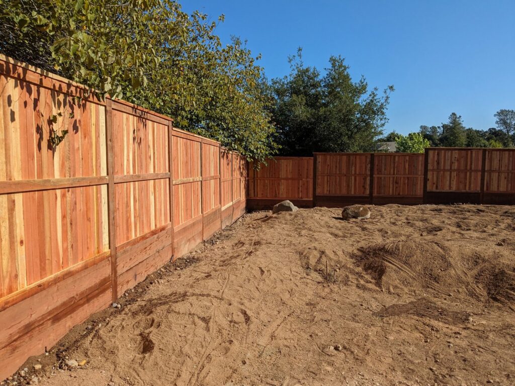A new wooden privacy fence installed in a backyard by Sacramento Valley Fencing in Sacramento, CA.