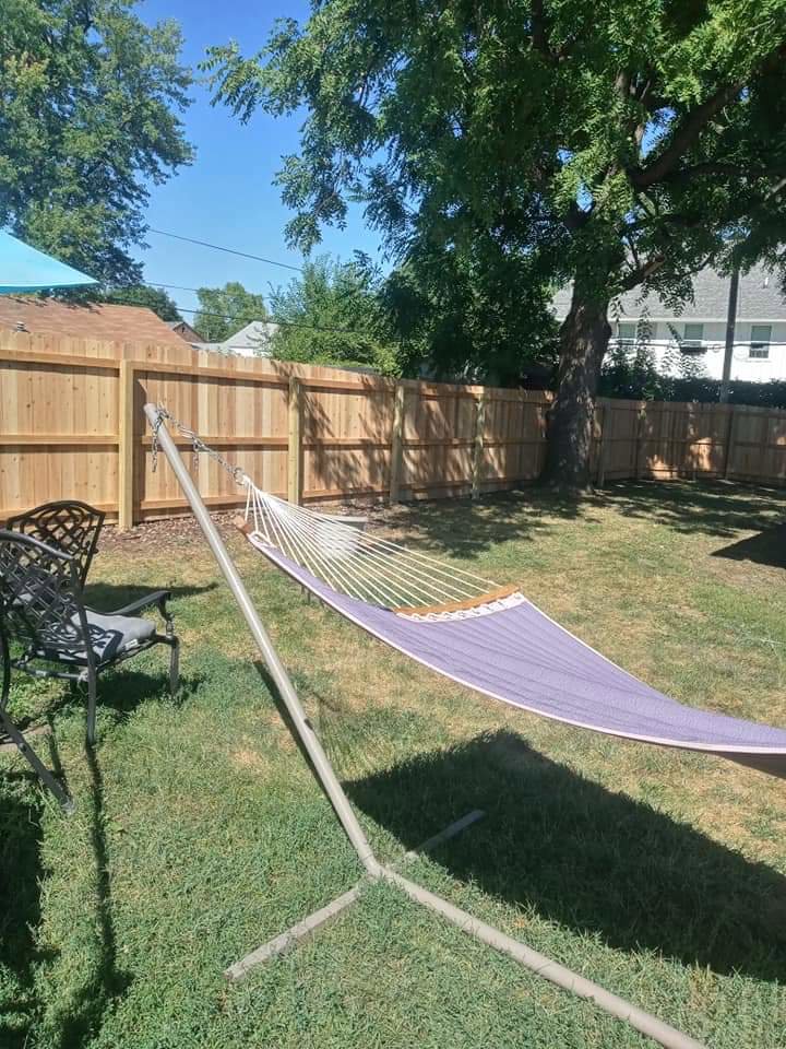 A newly installed wooden privacy fence in a residential backyard, completed by Stallworth Home Improvement in Des Moines, IA.