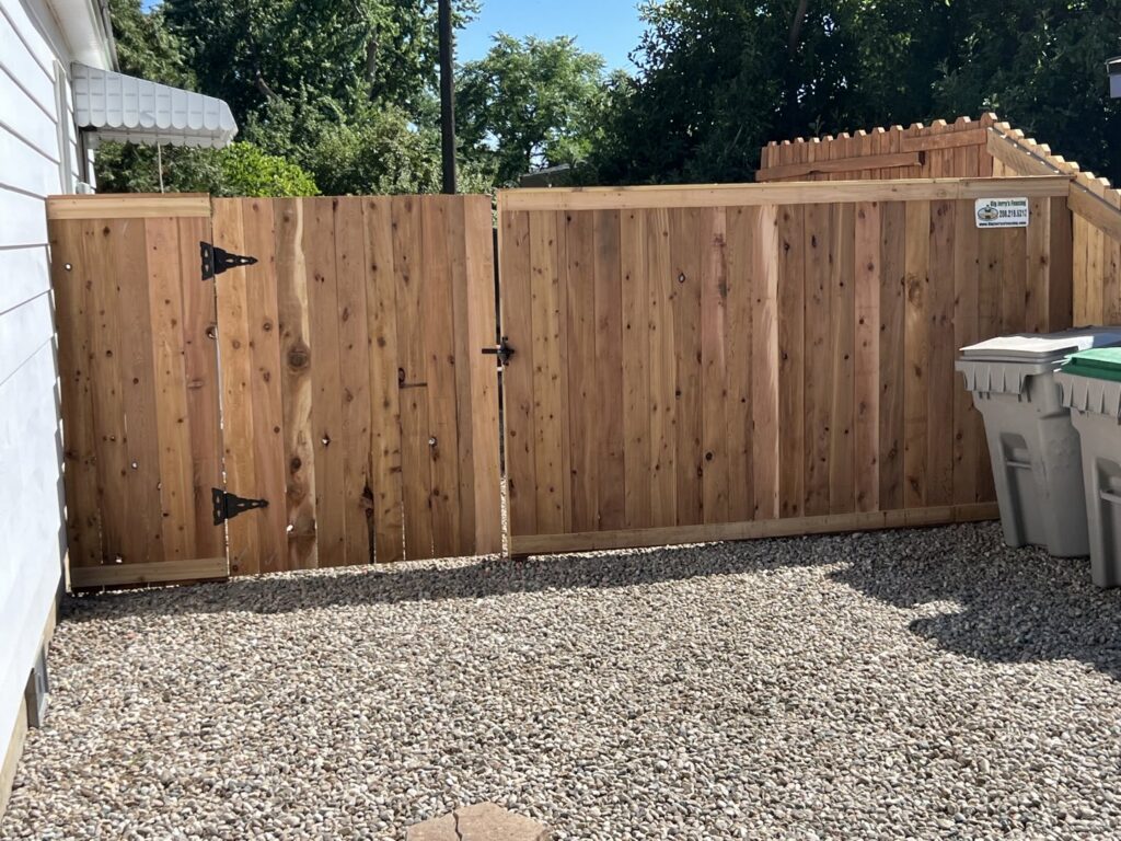 A newly installed wooden privacy fence with a double gate by Big Jerry's Fencing of Boise ID in Holly Springs, NC.