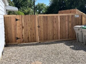 A newly installed wooden privacy fence with a double gate by Big Jerry's Fencing of Boise ID in Holly Springs, NC.
