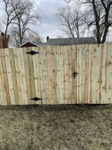 A newly installed wooden privacy fence with a matching gate by Affordable Fence Builders in Dayton, OH.