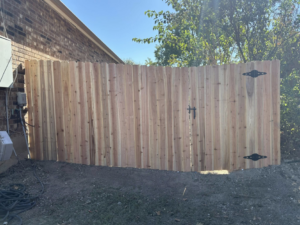 A newly installed wooden privacy fence with a gate by Olson Handyman Services, LLC in New Braunfels, TX