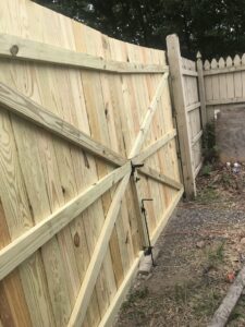 A newly installed wooden privacy fence gate by The Fence Dr. in Scranton, PA.