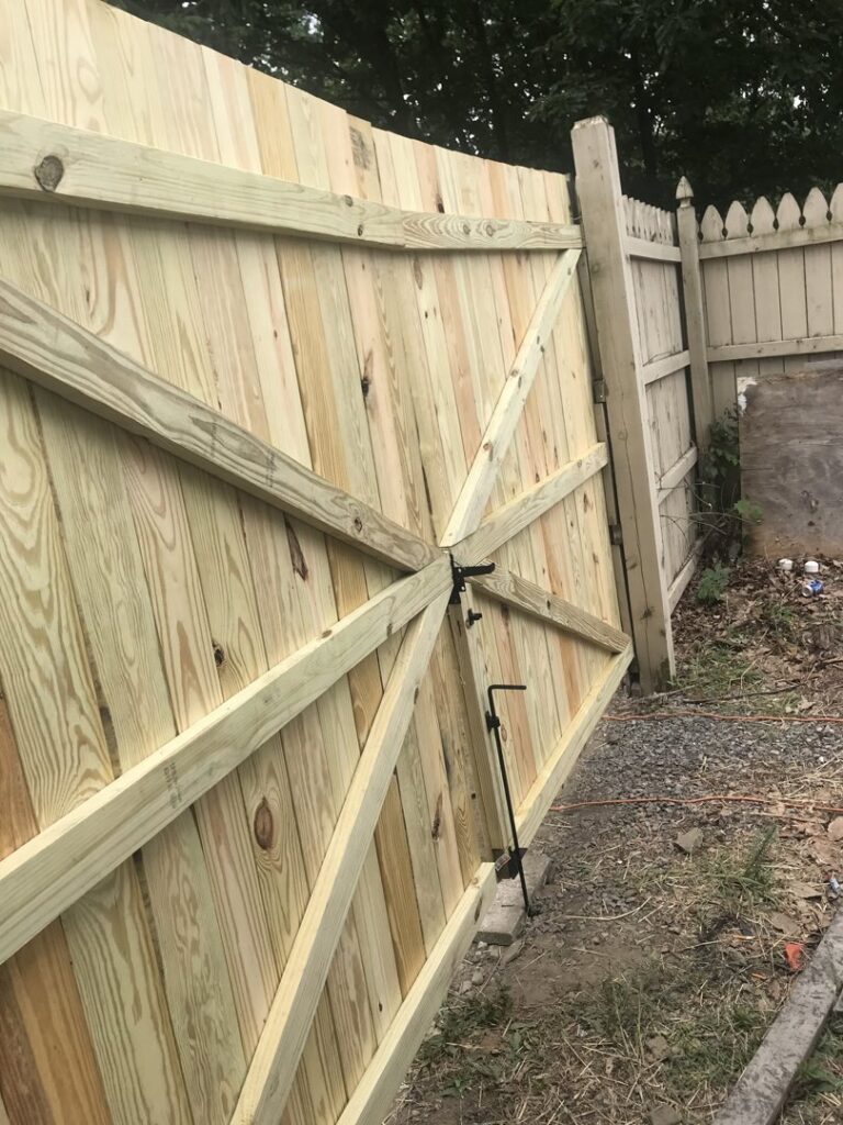 A newly installed wooden privacy fence gate by The Fence Dr. in Scranton, PA.