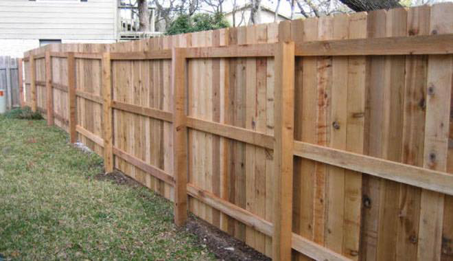 A newly installed wooden privacy fence in a backyard by Fence Masters Upstate SC in Greenville, SC