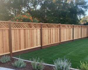 A newly installed wooden privacy fence with a decorative lattice top by Horizon Fence & Custom Gates, Inc. in Orangevale, CA.