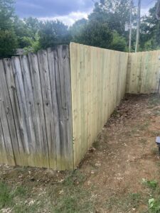 A new wooden privacy fence installed next to an older fence, demonstrating replacement work by First Responder Outdoor Construction LLC in Bartlett, TN.