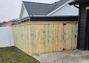 A newly installed wooden privacy fence enclosing a residential area, built by Row Fencing and Services in Williston, ND.