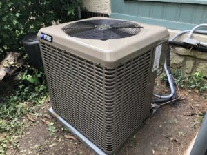 A newly installed York air conditioning outdoor unit by M.D. Repair Heating and Cooling in Oak Grove, MO.