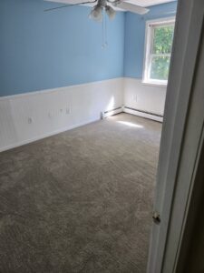 A newly carpeted bedroom showcasing quality installation by Essex Companies LLC in Salem, NH.