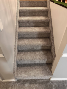 A newly installed grey carpet on a residential staircase by All about flooring utah in Salt Lake City, UT.
