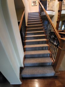 A beautifully installed gray carpet on a residential staircase by Zelo Flooring in San Diego, CA.