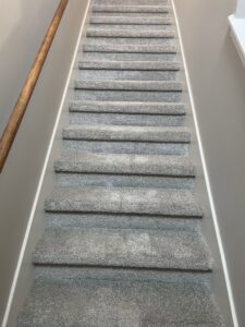 Newly installed gray carpet on stairs in a residential home by 180 Degree Floors, a carpet contractor in Nashville, TN.