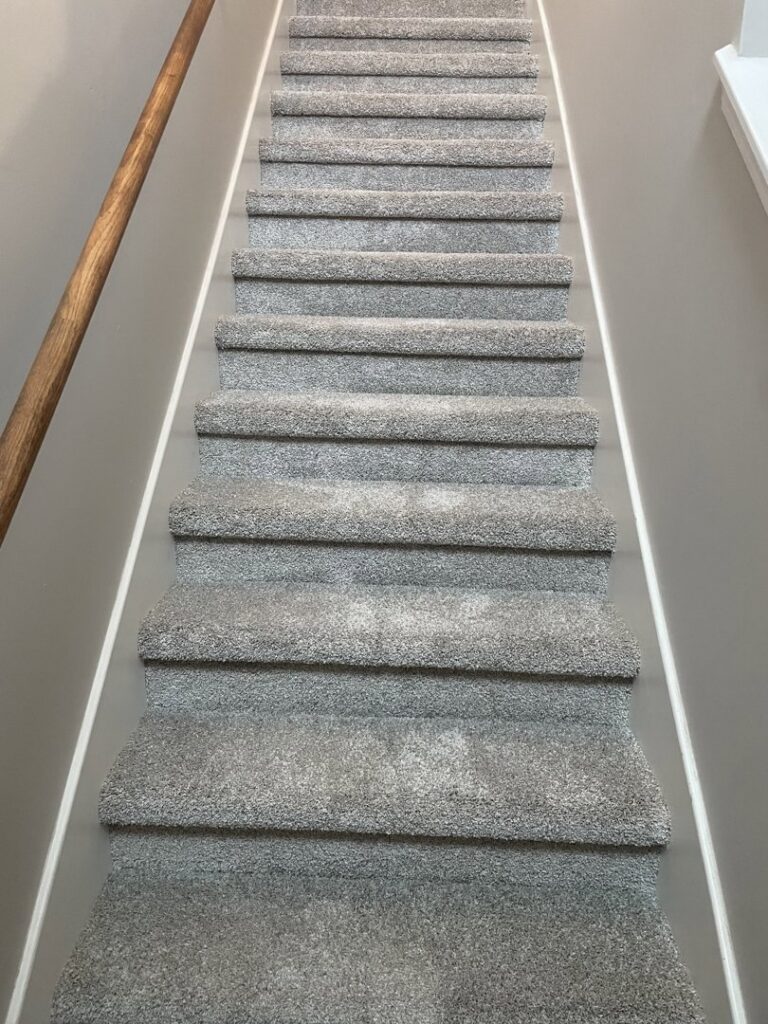 Newly installed gray carpet on stairs in a residential home by 180 Degree Floors, a carpet contractor in Nashville, TN.